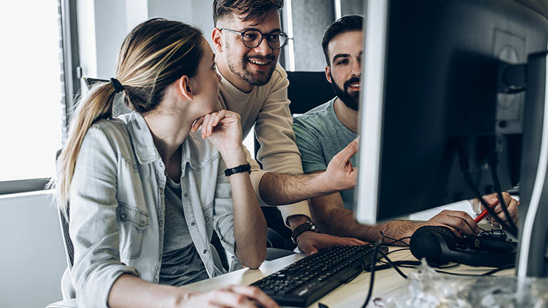 three young professionals at computer